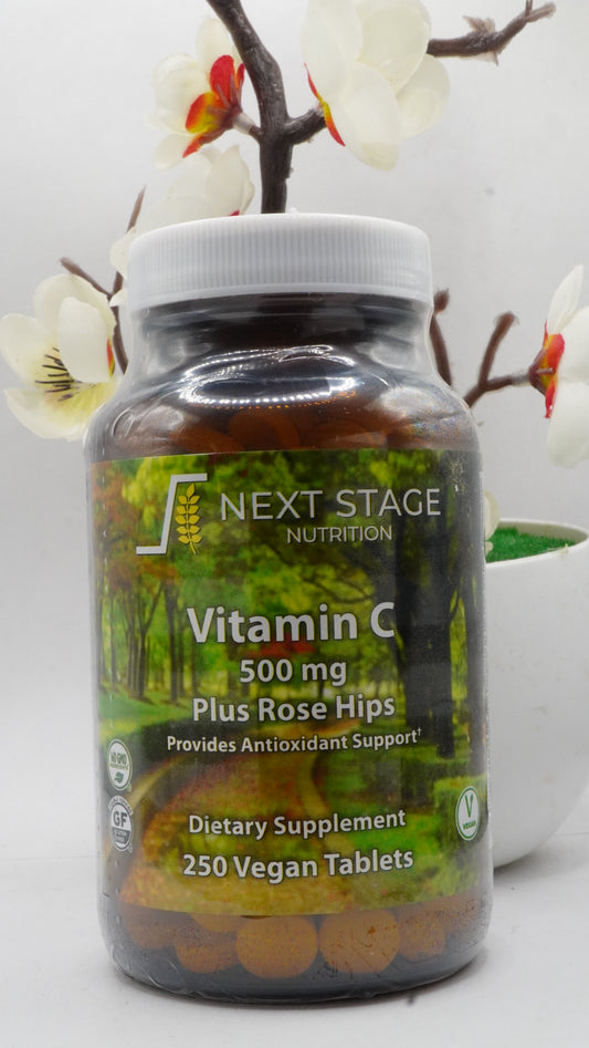 Supplement bottle labeled 'Next Stage Nutrition' with decorative flowers in the background